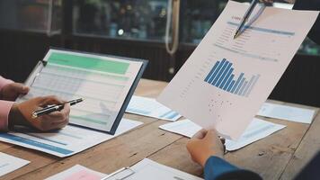 Business people working on papers with graphs video