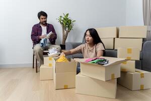 Creating lasting memories in their new nest. Happy young family couple renters tenants engaged in packing up photo