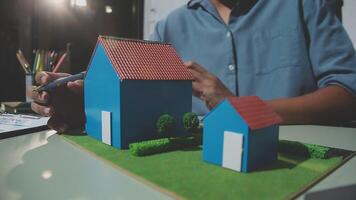 A man is working on a model of a house video