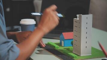 A person is using a model of a building video