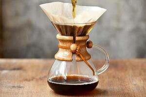 Brewing drip filter coffee on wooden table photo