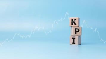 Indicators business and KPI to improve organization performance, Wooden blocks printed with the abbreviation KPI on blue background, Marketing, Corporate financial strategies, Indicator of success. photo