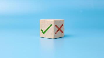 Right and wrong symbols, Green correct sign mark and red cross mark which print on wooden for approve and reject business project proposal, True and False symbols accept rejections for evaluation. photo