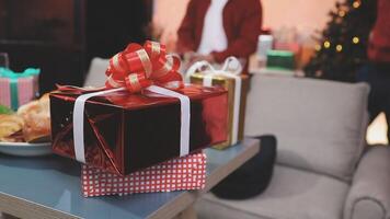 A man is standing in front of a table with presents video