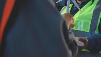 A man in a safety vest is handing a paper to another man video