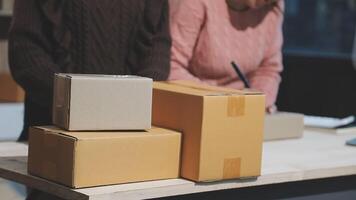 A man and woman are standing near boxes video
