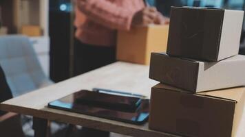 A stack of boxes on a desk with a person sitting in front of it video