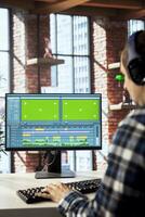 editor selecting key frames to use while doing montage, working from home on chroma key computer. Close up of man using mouse to edit movie project footage on isolated screen PC photo