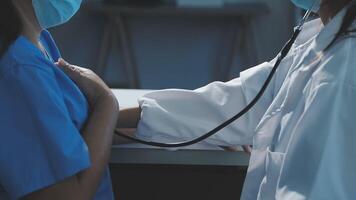 A doctor checking the heart rate of a patient video