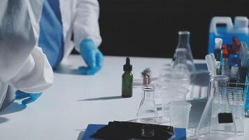 A person in a lab coat is working on a table video
