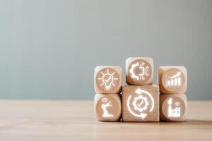 Wooden blocks with digital icons symbolize automation, technology, and efficiency in modern industry and innovation. photo