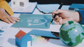 Business people working on a project with a globe and a paper with the word net video