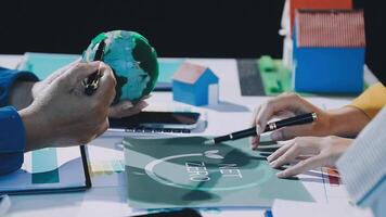 People working on a project with a globe on the table video