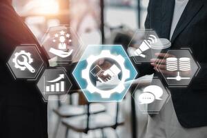 Visual representation of customer relationship management with digital icons and business professionals. photo