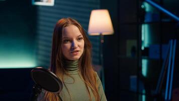 Social media star uses professional gear to capture welcoming intro for vlogging channel, interacting with online community. Influencer connects with loyal fanbase during live stream, camera A closeup photo