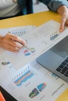 Close-up of hands reviewing financial charts and graphs, highlighting business analysis and data interpretation. photo