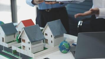Two people are looking at a model of a house video