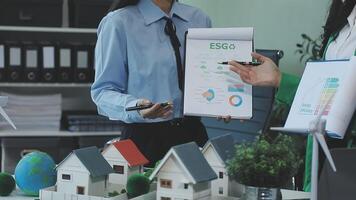 Two people are holding up a piece of paper with a house on it video