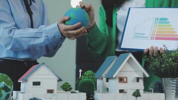 Energy efficiency concept with green house and house model video