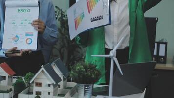 Two people holding up papers and a model of a house video