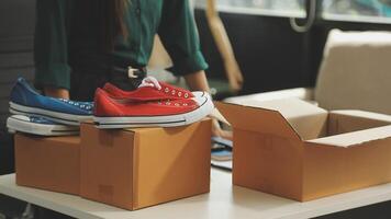 A woman is packing shoes on top of boxes video