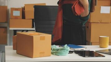 A woman is standing in front of a desk with boxes and other items video