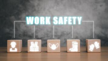 Work safety concept, Wooden cube block on desk with work safety icon with copy space. photo