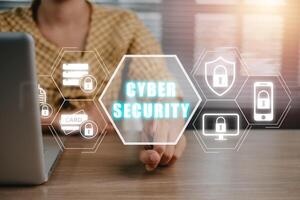 Firewall and internet security concept, Person hand touching VR screen protection icon on office desk, Data protection and network security, insurance business. photo