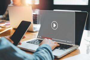 streaming on internet, Person watching online movie or TV series on laptop computer, Concept about subscription based live digital stream. photo