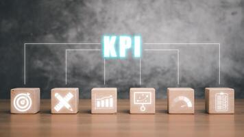 KPI Key performance indicator business and industrial analysis concept, Wooden block with KPI icon on virtual screen. photo