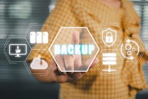 Backup storage data internet technology business concept, Person hand touching backup icon on virtual screen. photo