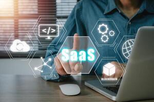 SaaS concept, software as a service, Businessman hand working on laptop to synchronize on SaaS host server to working on system for technology and business concept photo