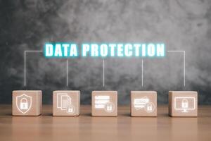 Data protection privacy concept, Wooden block on wooden desk with data protection icon on virtual screen, GDPR, EU. photo