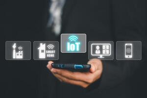 IOT Internet of things, Businesswoman using smart phone with VR screen Internet of things icon background, Digital transformation, Modern technology concept. photo