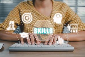 Skill knowledge ability business internet technology concept, Woman hand typing keyboard on desk with skills icon on screen display. photo