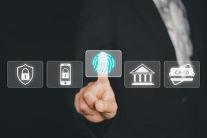 Business woman hand using fingerprint indentification to access personal financial data, Fingerprint scan provides security access with biometrics identification. photo