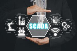SCADA Supervisory control and data acquisition technology concept, Person hand holding SCADA icon on virtual screen. photo