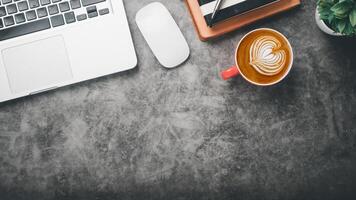 Office desk workplace with laptop, mouse, pen, note and cup of coffee, Top view flat lay with copy space. photo
