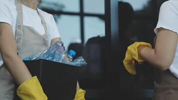 Two people in aprons holding plastic bottles video