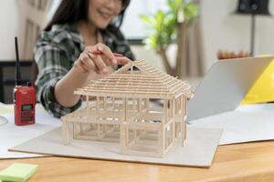 Architect making architectural model. Data working and tablet laptop. Architect explaining project plan to clients. photo