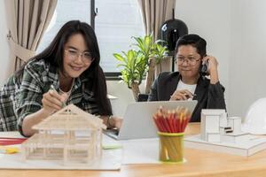 Two architects discussing new project. Data working and tablet laptop. Architect explaining project plan to clients. photo