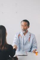 A doctor shaking hands with a patient photo