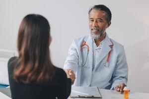 A doctor shaking hands with a patient photo