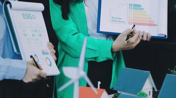 Two people holding papers with an energy chart on them video