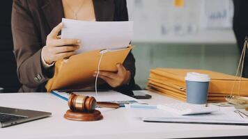 A woman in a business suit is holding a piece of paper and a pen video