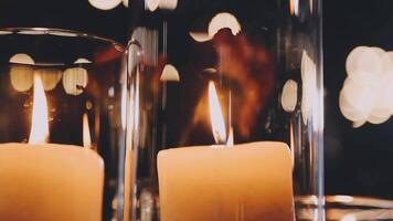 Candles in glass vases with bokeh effect video