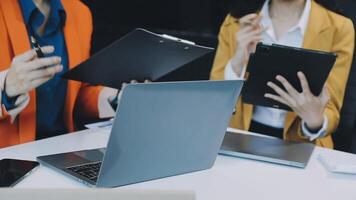 Two business people are working on laptops video