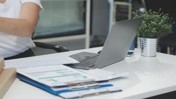 A woman is holding a box with paperwork on her desk video