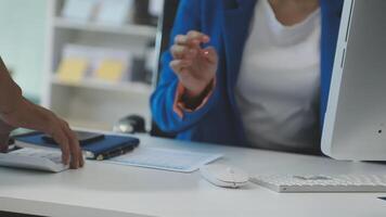 A woman is using a computer keyboard and mouse video