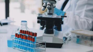 A person in a lab coat is looking at a microscope video